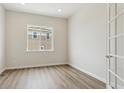 Versatile room featuring attractive flooring, a window, and a stylish door with glass panes at 4978 Hickory Oaks St, Castle Rock, CO 80104