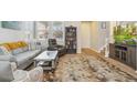 Cozy living room with neutral decor, a plush area rug, and comfortable seating, perfect for relaxation at 3178 Geneva Ct, Denver, CO 80238