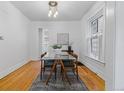 Bright dining room featuring wood floors, large windows, modern lighting and a sleek glass table, great for entertaining at 39 S Grant St, Denver, CO 80209