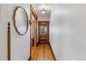 Bright hallway featuring hardwood floors and decorative mirror at 39 S Grant St, Denver, CO 80209