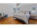 Bright bedroom with hardwood floors, chair, and a large window at 39 S Grant St, Denver, CO 80209