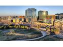 An elevated view displays Denver's skyline adjacent to a lovely park, blending city and nature at 1700 Bassett St # 504, Denver, CO 80202