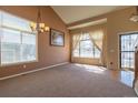 Open living room with carpet, natural light, and neutral paint at 6786 Silverleaf Ave, Firestone, CO 80504