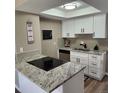 Bright kitchen with stainless steel appliances, granite countertops, and white cabinetry at 2746 S Kenton Ct, Aurora, CO 80014