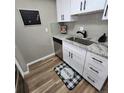Updated kitchen features stainless steel appliances, modern white cabinets and granite countertops at 2746 S Kenton Ct, Aurora, CO 80014