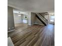 Open-concept living area with modern flooring and staircase at 2746 S Kenton Ct, Aurora, CO 80014
