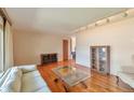 Spacious living room featuring hardwood floors, ample lighting, and a seamless layout at 1304 S Harlan St, Lakewood, CO 80232