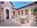 Charming outdoor patio with comfortable seating, string lights, decorative plants, and brick pavers at 9617 S Shadow Hill Cir, Lone Tree, CO 80124