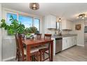 Bright kitchen with a dining area and lots of natural light from the large window at 2954 E 101St Ave, Thornton, CO 80229