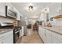 Modern white kitchen featuring stainless steel appliances and granite countertops at 2954 E 101St Ave, Thornton, CO 80229