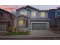 Charming two-story home with a well-maintained lawn, stone accents, and a convenient two-car garage at 4672 Basalt Ridge Cir, Castle Rock, CO 80108