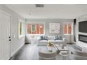 Bright living room featuring a fireplace, modern decor, ample natural light, and stylish furnishings at 1345 Holly St, Denver, CO 80220