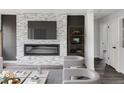 Modern living room with a sleek fireplace feature wall, contemporary furnishings, and neutral tones at 1345 Holly St, Denver, CO 80220