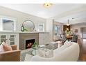 Cozy living room with a fireplace, modern furniture, and seamless flow into the dining area at 3311 N York St, Denver, CO 80205