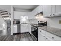 Well-lit kitchen with white cabinets, subway tile backsplash, stainless steel appliances and granite countertops at 8905 Field St # 91, Westminster, CO 80021