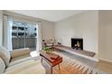 Inviting living room with a brick fireplace, sliding glass door, and modern decor at 4110 Hale Parkway Pkwy # 3J, Denver, CO 80220
