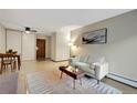 Open-concept living area with modern decor, light wood floors, and dining area at 4110 Hale Parkway Pkwy # 3J, Denver, CO 80220