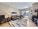 Bright living room featuring a fireplace and a sliding glass door that opens to the outdoor balcony at 3260 47Th St # 108A, Boulder, CO 80301