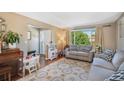 Spacious living room with a cozy atmosphere, featuring hardwood floors and a large window at 7780 S Kendall Blvd, Littleton, CO 80128