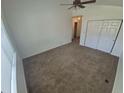 This carpeted bedroom has a ceiling fan and a double door closet at 894 S Krameria St, Denver, CO 80224