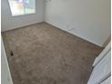 This is a carpeted bedroom with a window to let in natural light at 894 S Krameria St, Denver, CO 80224