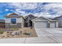 Inviting home exterior showcasing stone accents, gravel landscaping, and a well-maintained yard at 815 Alumroot St, Castle Rock, CO 80104
