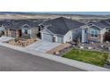 Attractive home exterior with three-car garage, low-maintenance yard, and mountain views at 815 Alumroot St, Castle Rock, CO 80104