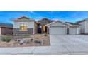 Well-lit home exterior with stone details, manicured landscaping, and a welcoming entrance at 815 Alumroot St, Castle Rock, CO 80104