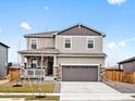 Charming two-story home with stone accents, covered porch, and a two-car garage at 8840 Sedalia St, Commerce City, CO 80022