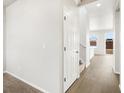 Bright hallway with sleek, modern flooring leading to the staircase at 8840 Sedalia St, Commerce City, CO 80022