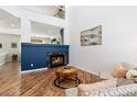 Bright living room with a fireplace, wood floors, and stylish decor at 22142 E Belleview Place, Aurora, CO 80015