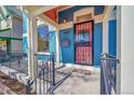 Inviting blue home entrance with a secure iron gate, and decorative accents at 169 W Byers Pl, Denver, CO 80223