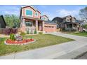 Charming two-story home with brick accents, a well-manicured lawn, and a cozy front porch at 11373 Kearney Way, Thornton, CO 80233