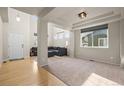 Bright living room with soaring ceilings, large windows, a neutral color palette, and modern finishes at 11373 Kearney Way, Thornton, CO 80233