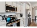 Close up of kitchen appliances and white subway tile backsplash at 6737 S Tempe Ct, Aurora, CO 80016