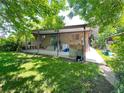 Spacious backyard featuring a covered patio area perfect for outdoor entertaining and leisure at 1115 S Harlan St, Lakewood, CO 80232