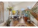 Dining area with large windows, stylish decor, hardwood floors, and ample natural light at 12616 Jersey W Cir, Brighton, CO 80602