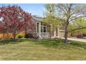 Attractive home with well-kept lawn, stone accents, and inviting front porch at 12616 Jersey W Cir, Brighton, CO 80602