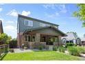 Charming two-story home with a brick and gray exterior, inviting front porch, and well-maintained front yard at 2669 N Cherry St, Denver, CO 80207