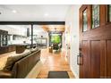 Bright open-concept living space with hardwood floors, modern kitchen, and seamless flow to the dining area at 2669 N Cherry St, Denver, CO 80207