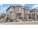 Attractive townhouse with contemporary gray siding, stone accents, a small front porch, and low-upkeep landscaping at 22863 E Tufts Ave # A, Aurora, CO 80015