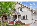 Attractive two-story home with a well-maintained lawn and inviting front porch, with blue chairs at 1526 S Gaylord St, Denver, CO 80210