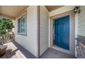 Inviting front porch and entry featuring a stylish blue door with views to the home's interior at 21482 E Idyllwilde Dr, Parker, CO 80138