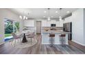 Bright eat-in kitchen with island, granite countertops, stainless steel appliances and sliding doors to the outside at 21482 E Idyllwilde Dr, Parker, CO 80138