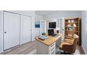 Bright home office with built-in shelving, modern desk, and French doors at 21482 E Idyllwilde Dr, Parker, CO 80138
