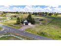 Sprawling property with a home, garage, barn, and fenced pastures at 17800 E Hinsdale Ave, Foxfield, CO 80016
