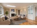Bright living room with a fireplace, hardwood floors, and an abundance of natural light at 3127 And 3125 N Raleigh St, Denver, CO 80212