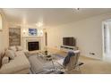 Spacious living room with a fireplace, plush seating, and carpeted floors at 3127 And 3125 N Raleigh St, Denver, CO 80212