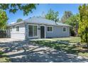 A quaint one story house with a well-maintained lawn and neutral-colored exterior at 967 Victor St, Aurora, CO 80011