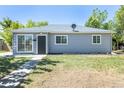Charming one-story home with a well-manicured lawn, and a classic exterior design at 967 Victor St, Aurora, CO 80011